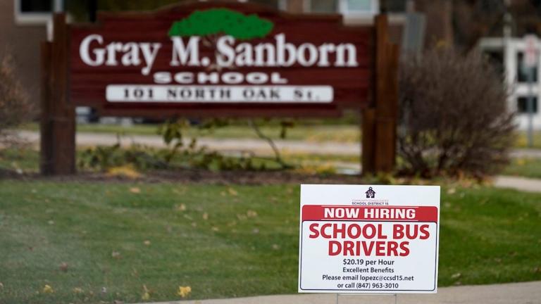 A hiring sign shows outside of Gray M. Sanborn Elementary School in Palatine, Ill., Thursday, Nov. 5, 2020. Illinois reports biggest spike in unemployment claims of all states. (AP Photo/Nam Y. Huh)