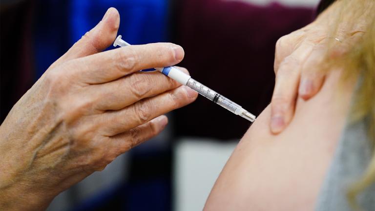 A health worker administers a dose of a COVID-19 vaccine during a vaccination clinic at the Keystone First Wellness Center in Chester, Pa., on Dec. 15, 2021.  (AP Photo / Matt Rourke, File) 