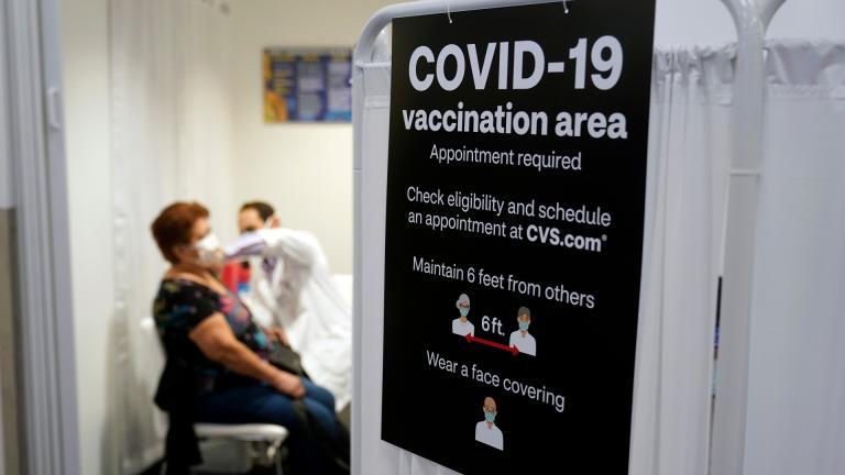 In this March 1, 2021, file photo, a patient receives a shot of the Moderna COVID-19 vaccine next to a guidelines sign at a CVS Pharmacy branch in Los Angeles. (AP Photo / Marcio Jose Sanchez, File)