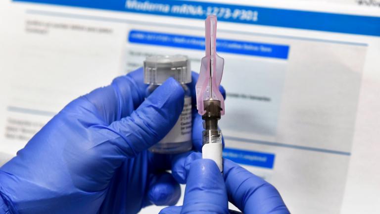 In this July 27, 2020, file photo, a nurse prepares a shot as a study of a possible COVID-19 vaccine, developed by the National Institutes of Health and Moderna Inc., gets underway in Binghamton, N.Y. (AP Photo / Hans Pennink, File)