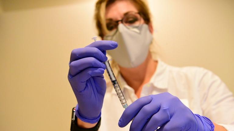 This September 2020, file photo provided by Johnson & Johnson shows a pharmacist preparing to give an experimental COVID-19 vaccine. (Johnson & Johnson via AP, File)