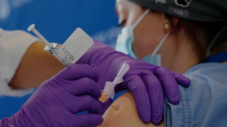 Catalina Gonzalez-Marques, an emergency medical physician, receives the Pfizer-BioNTech coronavirus vaccine at Brigham and Women’s Hospital, Wednesday, Dec. 16, 2020, in Boston. (Brian Snyder / Pool via AP)
