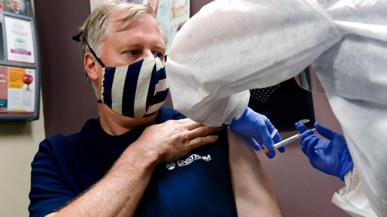 Nurse Carolyn Grausgruber gives volunteer Ithaca firefighter Wade Bardo, of Erin, N.Y., an injection as the world’s biggest study of a possible COVID-19 vaccine, developed by the National Institutes of Health and Moderna Inc., gets underway Monday, July 27, 2020, in Binghamton, N.Y. (AP Photo / Hans Pennink)