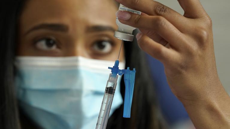 Licensed practical nurse Yokasta Castro, of Warwick, R.I., draws a Moderna COVID-19 vaccine into a syringe at a mass vaccination clinic, Wednesday, May 19, 2021, at Gillette Stadium, in Foxborough, Mass. (AP Photo / Steven Senne)