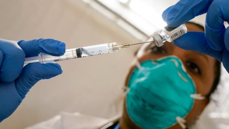 In this Jan. 15, 2021, file photo, Dr. Yomaris Pena, internal medicine physician with Somos Community Care, extracts the Pfizer COVID-19 vaccine out of a vial at a vaccination site at the Corsi Houses in the East Harlem neighborhood of New York. (AP Photo / Mary Altaffer, File)