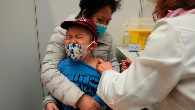 A boy receives a dose of China's Sinovac COVID-19 coronavirus vaccine at a community vaccination center in Hong Kong on Feb. 25, 2022. (AP Photo / Kin Cheung, File)
