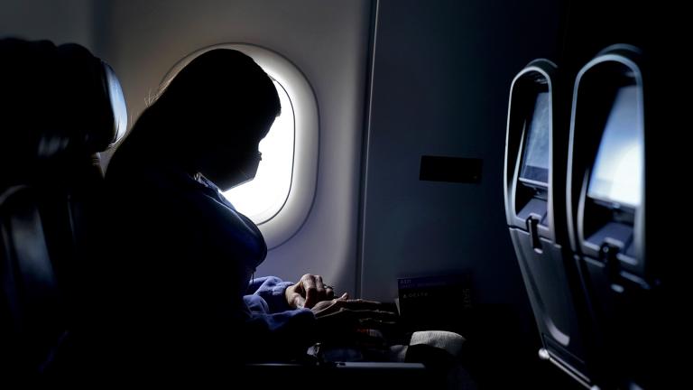 In this Wednesday, Feb. 3, 2021 file photo, a passenger wears a face mask during an airline flight after taking off from Atlanta. (AP Photo / Charlie Riedel)