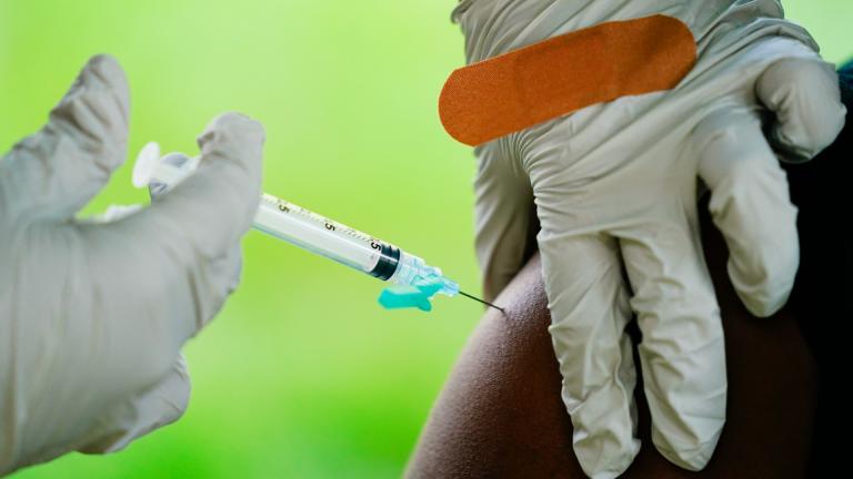 A health worker administers a dose of COVID-19 vaccine during a vaccination clinic in Reading, Pa. (AP Photo / Matt Rourke, File)