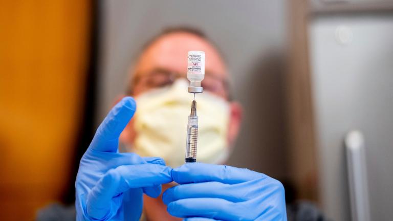 In this Jan. 12, 2021, file photo a pharmacist draws saline while preparing a dose of Pfizer's COVID-19 vaccine in Sacramento, Calif. (AP Photo / Noah Berger, Pool, File)