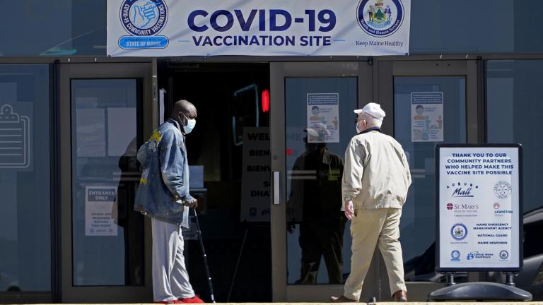 In this May 12, 2021, file photo, one man holds the door for another as they arrive at a COVID-19 vaccination clinic at the Auburn Mall in Auburn, Maine. (AP Photo / Robert F. Bukaty)