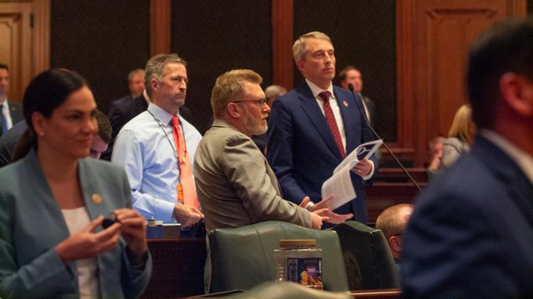 State Rep. Patrick Windhorst, R-Metropolis, reads the House rules as members of his party look on. His procedural maneuvering forced Democratic leadership to suspend the rules in order to get enough members in the chamber to pass the revenue plan. (Jerry Nowicki / Capitol News Illinois)