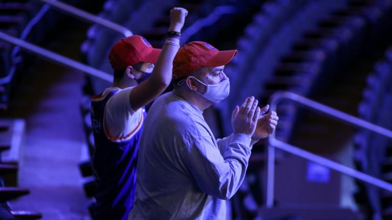 Fans cheer the New York Knicks coming out to warm up for an NBA basketball game against the Golden State Warriors on Tuesday, Feb. 23, 2021, in New York. A limited number of fans were allowed to attend. (Wendell Cruz / Pool Photo via AP)