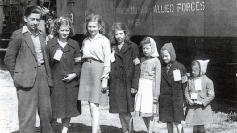 Weber siblings in front of Allied Forces train, Bremerhaven, November 1946. Left to right: Alfons Weber (17 years old), Senta Weber (16), Ruth Weber (14), Gertrude Weber (12), Renee Weber (10), Judith Weber (8), and Bela Weber (6). (Courtesy of Anna Andlauer)