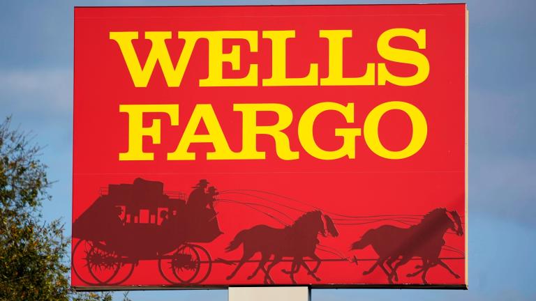 A Wells Fargo sign stands in front of a branch of the bank in Bradenton, Fla., Tuesday, Feb. 22, 2022. Consumer banking giant Wells Fargo is being ordered to pay $3.7 billion in fines and refunds to customers by U.S. government regulators, the largest fine to date against the bank. (AP Photo / Gene J. Puskar, File)