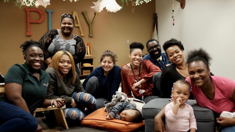 Participants, facilitators and organizers of the pilot program WePlay take a picture in the Chicago Children's Museum Pritzker Playspace, where they've been spending time over the past 12 weeks. (Courtesy of Chicago Children's Museum)