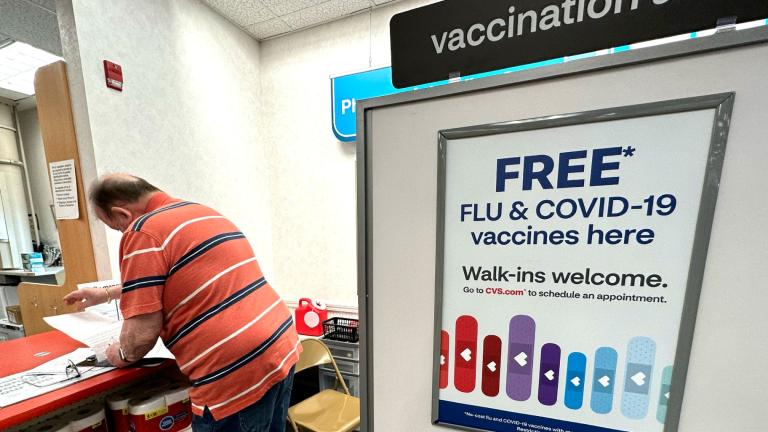 FILE - A sign for flu and covid vaccinations is displayed at a pharmacy store in Palatine, Ill., Wednesday, Sept. 13, 2023. (Nam Y. Huh / AP Photo)