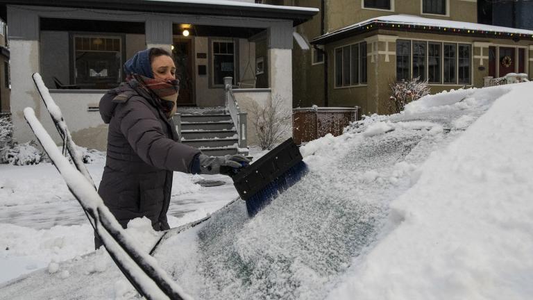 Sarah Lee clears snow off her vehicle in the Edgewater neighborhood, after a snowstorm in Chicago, Tuesday, Jan. 26, 2021. (Tyler LaRiviere / Chicago Sun-Times via AP) Sarah Lee clears snow off her vehicle in the Edgewater neighborhood, after a snowstorm in Chicago, Tuesday, Jan. 26, 2021. (Tyler LaRiviere / Chicago Sun-Times via AP)