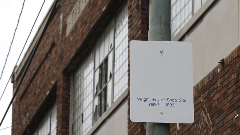 In this undated photo, a sign notes the site of the Wright brothers' bike shop outside the former Gem City Ice Cream building in Dayton, Ohio.  (Ty Greenlees / Dayton Daily News via AP, File)