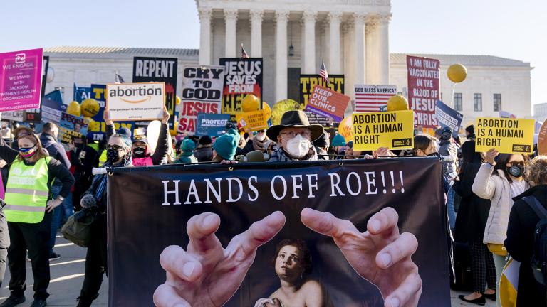 Stephen Parlato of Boulder, Colo., holds a sign that reads "Hands Off Roe!!!" as abortion rights advocates and anti-abortion protesters demonstrate in front of the U.S. Supreme Court, Dec. 1, 2021, in Washington, as the court hears arguments in a case from Mississippi, where a 2018 law would ban abortions after 15 weeks of pregnancy, well before viability. (AP Photo / Andrew Harnik, File) 