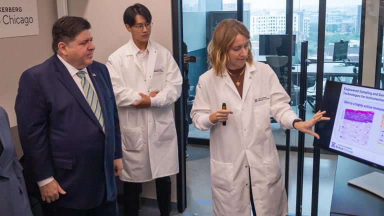Chan Zuckerberg Biohub Fellow Hope Burks presents her research into inflammation monitoring to Gov. J.B. Pritzker at a launch event for the Chan Zuckerberg Biohub Chicago. (Andrew Adams / Capitol News Illinois)