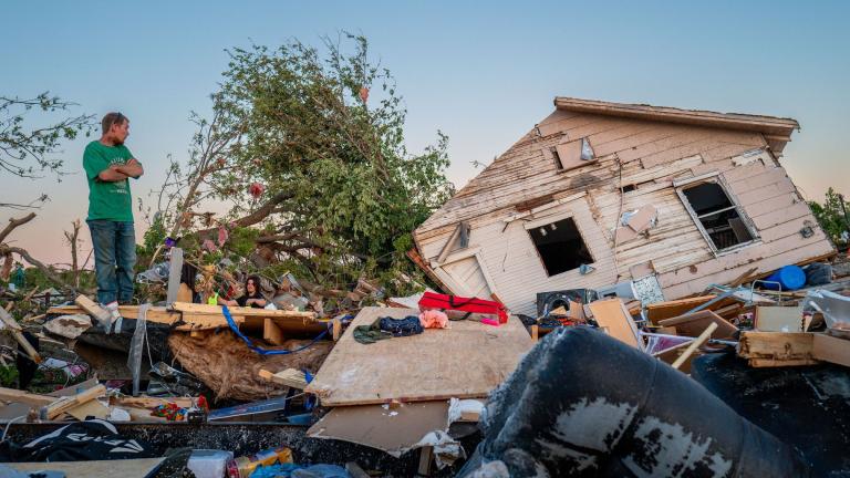 The Crowder family surveys their home destroyed by a tornado on May 7, 2024, in Barnsdall, Oklahoma. (Brandon Bell / Getty Images via CNN Newsource)