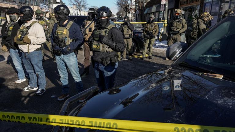 Federal agents stand guard at the scene of a shooting involving immigration agents in Minneapolis, Minnesota, on Jan. 24, 2026. (Tim Evans/Reuters via CNN Newsource)