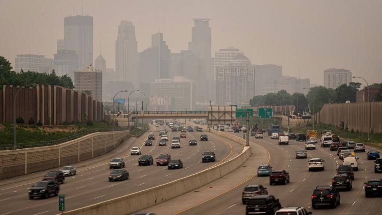 A haze enveloped Minneapolis as seen from the south across I-35W onJune 14, 2023. (Glen Stubbe / Star Tribune / Getty Images via CNN) 