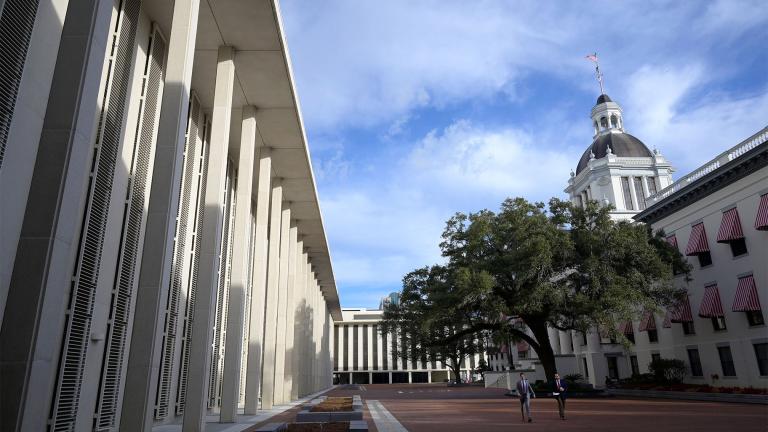 People walk between the Florida State Capitol building, left, and the Florida Historic Capitol Museum, right, during a legislative session on Wednesday, January 12, 2022, in Tallahassee, Florida. (Phelan M. Ebenhack / AP)