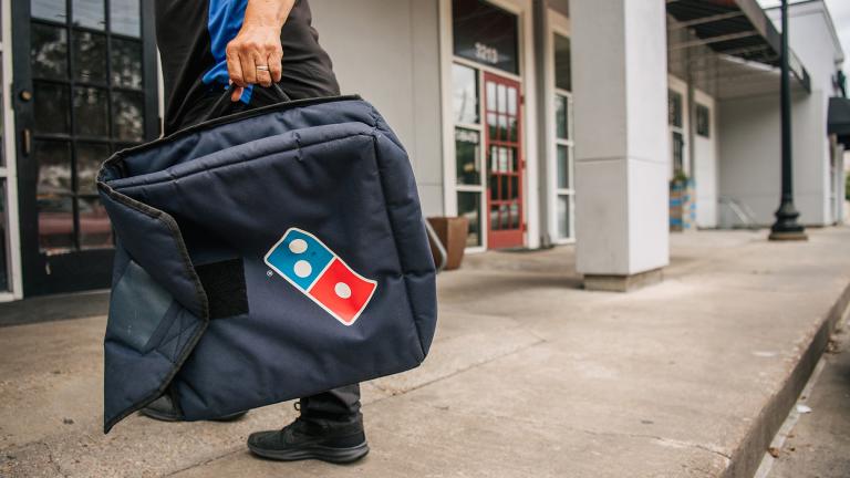 Domino’s Pizza is taking on delivery apps that charge extra fees with a new giveaway totaling $50 million worth of free food. (Brandon Bell / Getty Images) Domino’s Pizza is taking on delivery apps that charge extra fees with a new giveaway totaling $50 million worth of free food. (Brandon Bell / Getty Images)