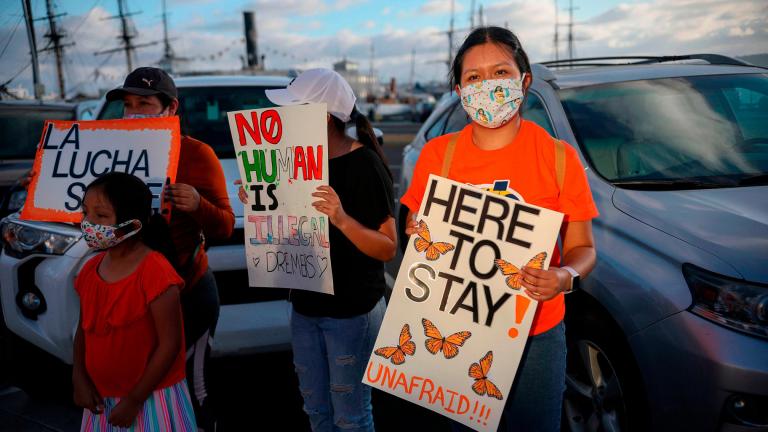 People hold signs during a DACA rally in California on June 18, 2020. (Sandy Huffaker / AFP / AFP via Getty Images)