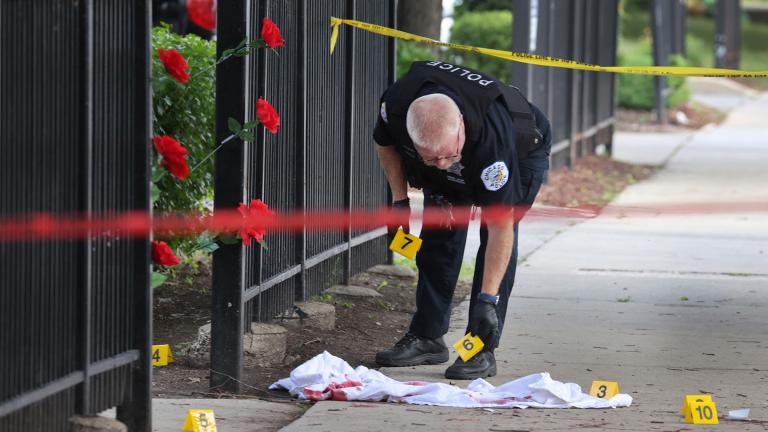 Police investigate a crime scene where three people were shot — one fatally — in the Bridgeport neighborhood on June 23 in Chicago. (Scott Olson / Getty Images)