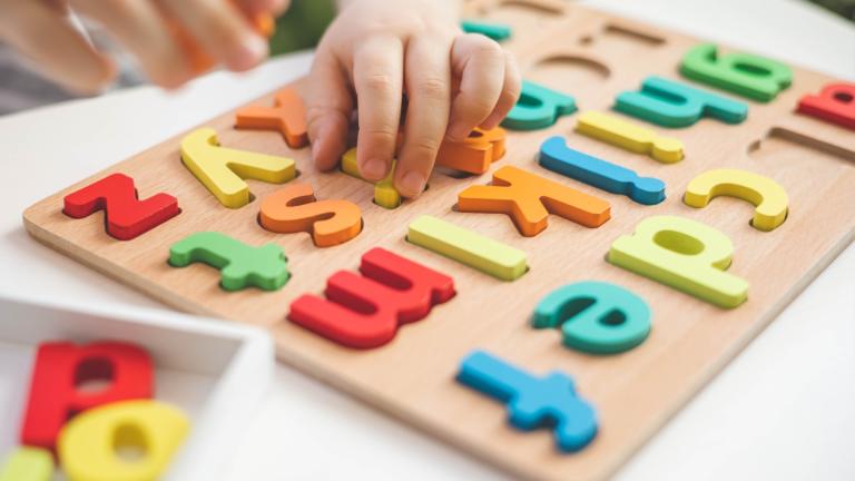 A child plays with block letters in a file photo. (Kostikova / iStock)