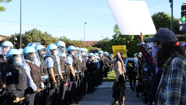 Protesters yell at a line of police officers at State and 35th streets, about 3 miles south of the Loop, where police set up a blockade on Sunday, May 31, 2020. (Evan Garcia / WTTW News) Protesters yell at a line of police officers at State and 35th streets, about 3 miles south of the Loop, where police set up a blockade on Sunday, May 31, 2020. (Evan Garcia / WTTW News)
