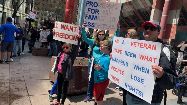 Patrick and Karen Swearingen and their four children protest Gov. J.B. Pritzker’s stay-at-home order Friday outside the Thompson Center. (Heather Cherone / WTTW News)