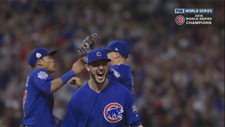 Chicago Cubs' Ben Zobrist holds the World Series MVP Trophy as he arrives  on stage during the 2016 World Series Champion celebration rally at the  Grant Park on November 4, 2016 in