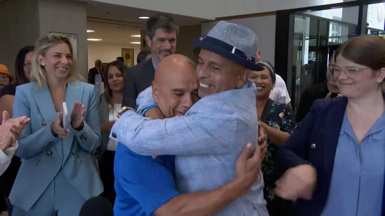 Jimmy Soto, right, and his cousin David Ayala embrace after receiving certificates of innocence at the Leighton Criminal Court Building on July 30, 2025 (WTTW News)