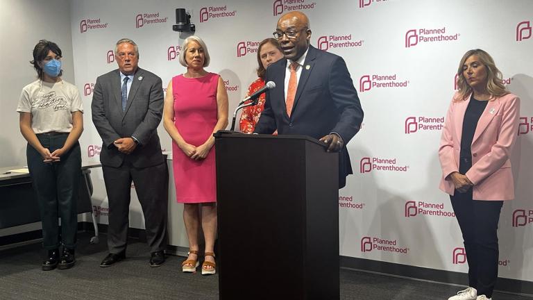 Illinois Attorney General Kwame Raoul stands with fellow abortion rights advocates on Thursday, July 27, 2023, to celebrate the signing of a bill allowing Illinoisans to sue crisis pregnancy centers that engage in “deceptive acts” aimed at deterring abortions. (Hannah Meisel / Capitol News Illinois)