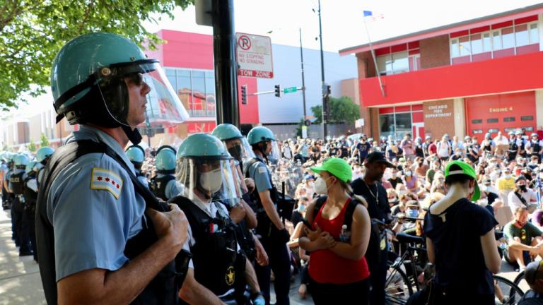 A line of Chicago police officers watch the demonstration at Division and Larrabee streets on June 2, 2020. Protesters assembled in front of a fire station and adjacent to the police department’s 18th District station. (Evan Garcia / WTTW News)