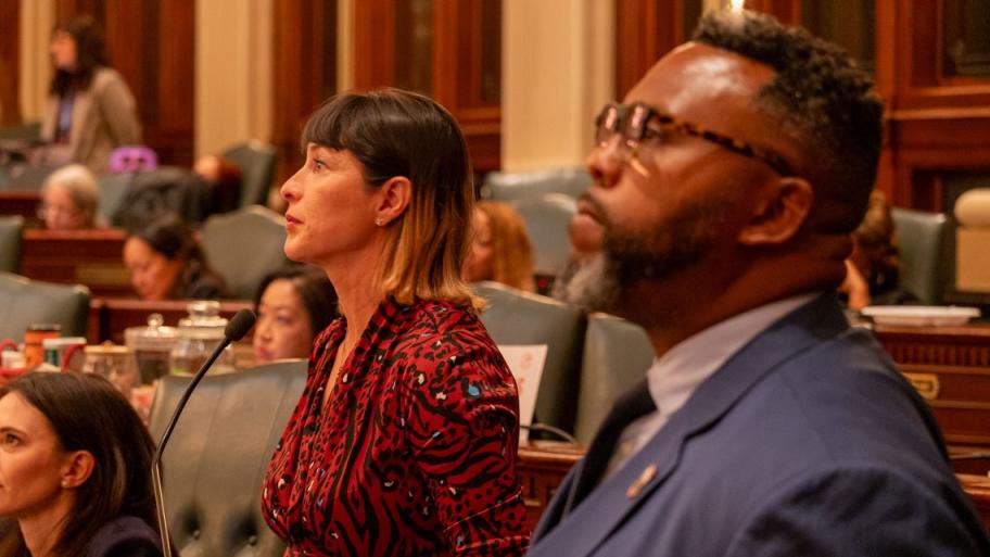 Reps. Eva-Dina Delgado and Kam Buckner watch the House of Representatives discuss their proposal to reform Chicagoland public transit. The two Chicago Democrats led a House working group tasked with overseeing negotiations. (Capitol News Illinois photo by Andrew Adams) 