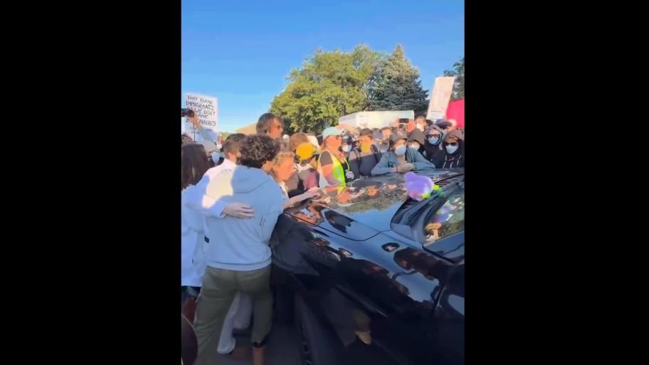 Congressional candidate Kat Abughazaleh, left, is seen along with a crowd around a vehicle on Sept. 26, 2025, outside the Broadview ICE facility. (Credit: Kat Abughazaleh)