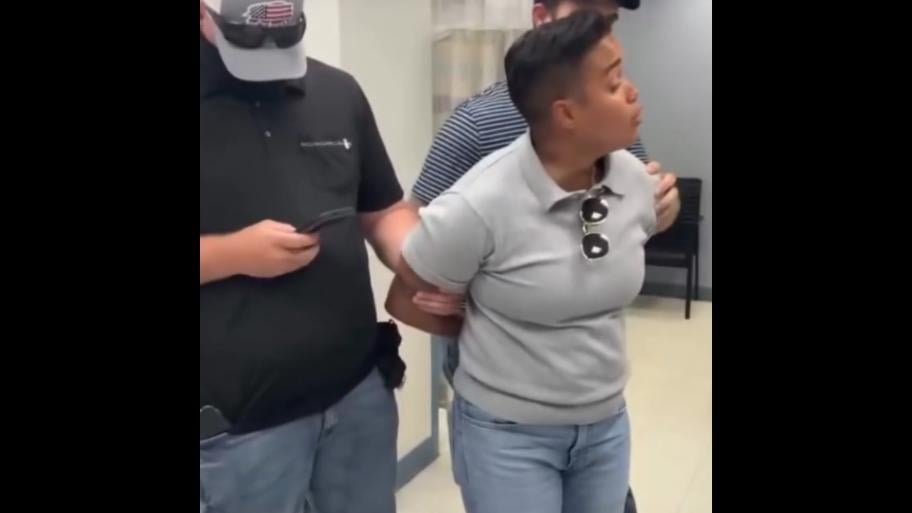 Ald. Jessie Fuentes is put into handcuffs by ICE agents while asking about a warrant for a detained man on Oct. 3, 2025. (Credit: 36th Ward Office)