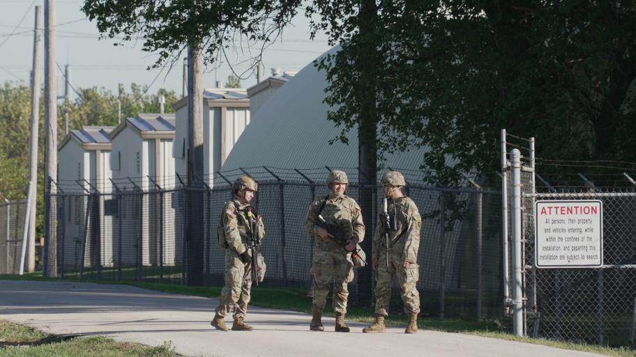 Military personnel in uniform, with the Texas National Guard patch on, are seen at the U.S. Army Reserve Center, Wednesday, Oct. 8, 2025, in Elwood, Ill., a suburb of Chicago. (AP Photo / Laura Bargfeld)