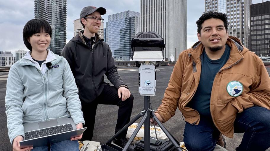 Shu-Yueh “Winnie” Liao, Benjamin Van Doren and J’orge Garcia installing an acoustic monitoring device atop Illinois Center in downtown Chicago; April 29, 2026. (Patty Wetli / WTTW News)