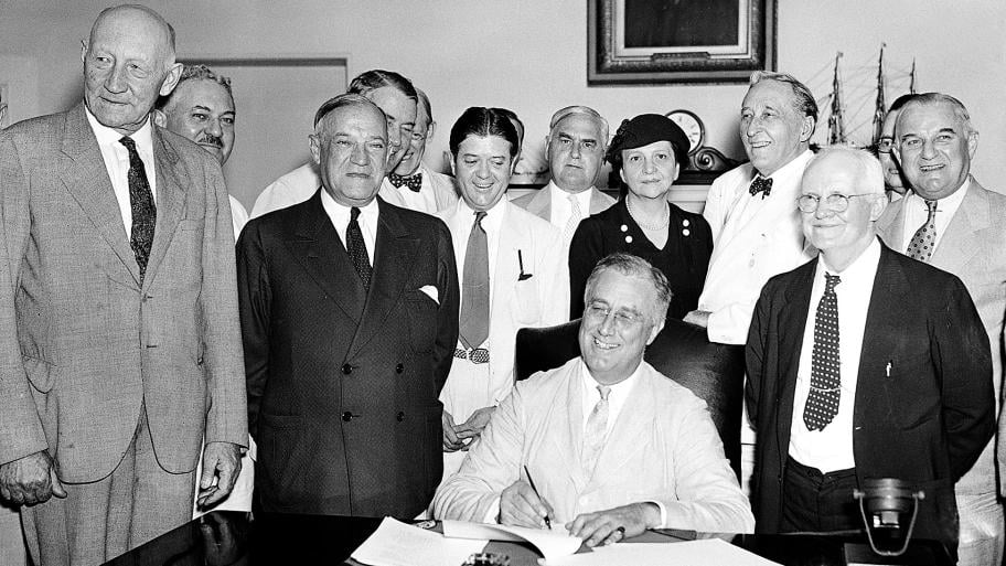 resident Franklin Roosevelt signs the Social Security Bill in Washington Aug. 14, 1935. (AP Photo, File)