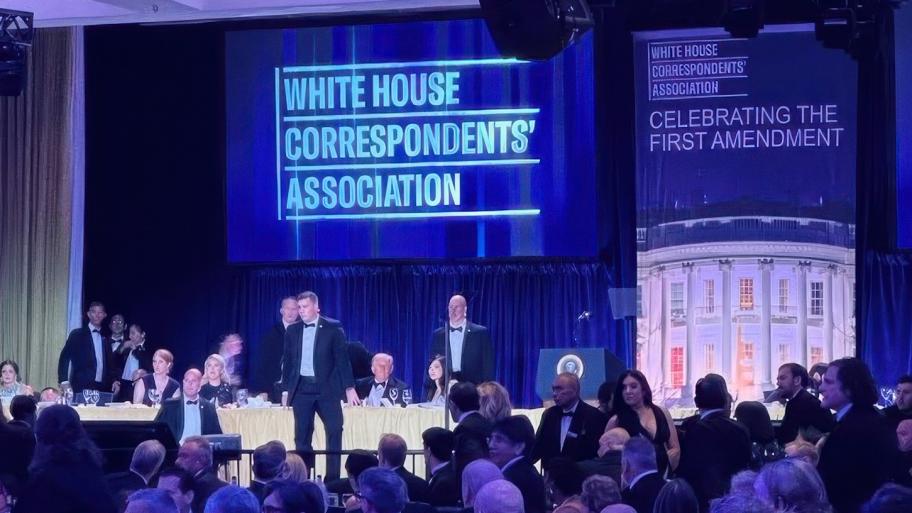 U.S. Secret Service agents surround President Donald Trump as he is taken from the stage after a shooting incident outside the ballroom during the White House Correspondents Dinner, Saturday, April 25, 2026, in Washington. (AP Photo / Alex Brandon)