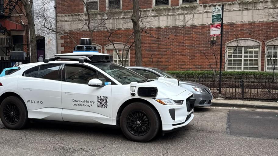 A Waymo vehicle drives through Chicago’s Near North Side on March 20, 2026, as the company begins testing and mapping the city. (Georgia Epiphaniou / Medill Illinois News Bureau) 