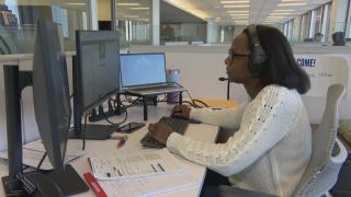 A worker at the 211 Resource Navigation Center. (WTTW News)