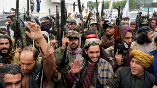 Taliban fighters celebrate one year since they seized the Afghan capital, Kabul, in front of the U.S. Embassy in Kabul, Afghanistan, Monday, Aug. 15, 2022. (AP Photo / Ebrahim Noroozi)