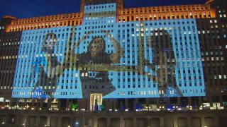 An image from dancers in the Bud Billiken Parade is projected onto the Merchandise Mart. (WTTW News)