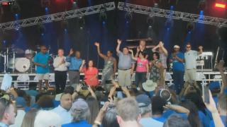 Gov. J.B. Pritzker and other state Democrats wave to the crowd at the Illinois State Fair’s Democrat Day on Aug. 17, 2022. (WTTW News)